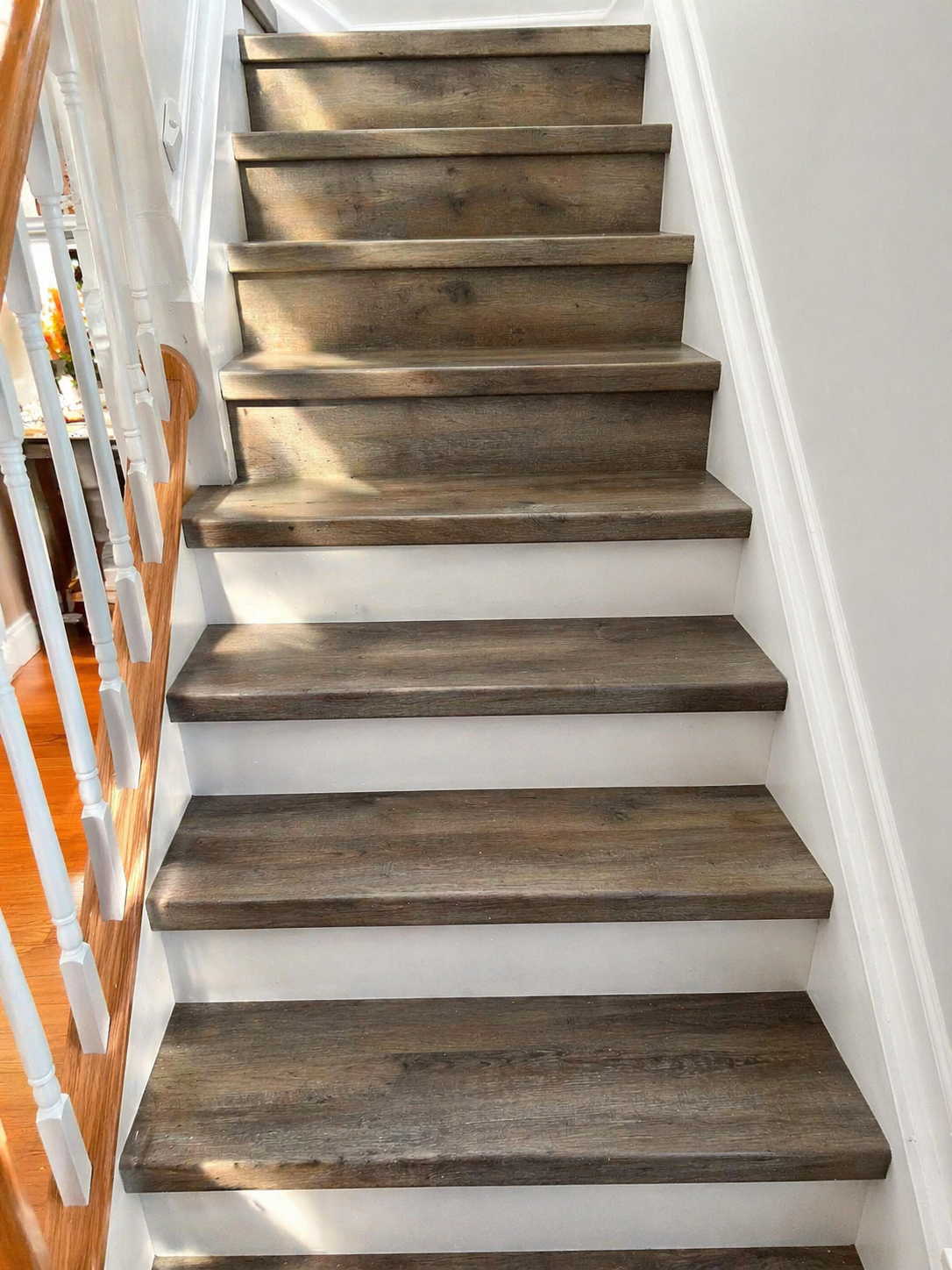 Rustic brown vinyl stair tread installation with white risers