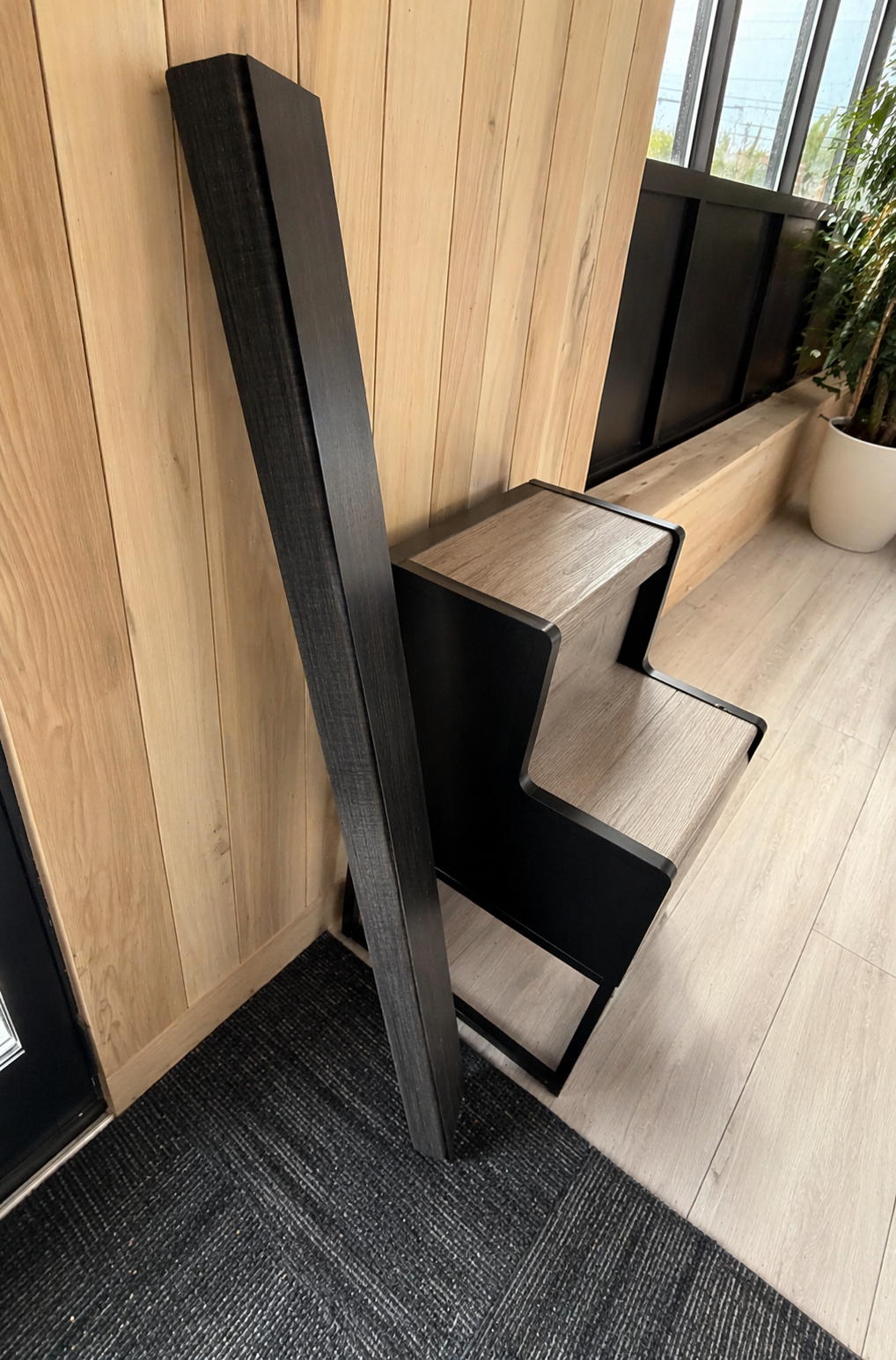 Black finished vinyl stair tread sample display in showroom